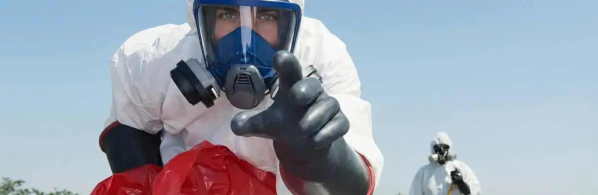 sewage clean up technician wearing protective gear handling biohazard materials in Buffalo, NY